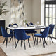 Dining room with a table and blue chairs in a well-lit room.