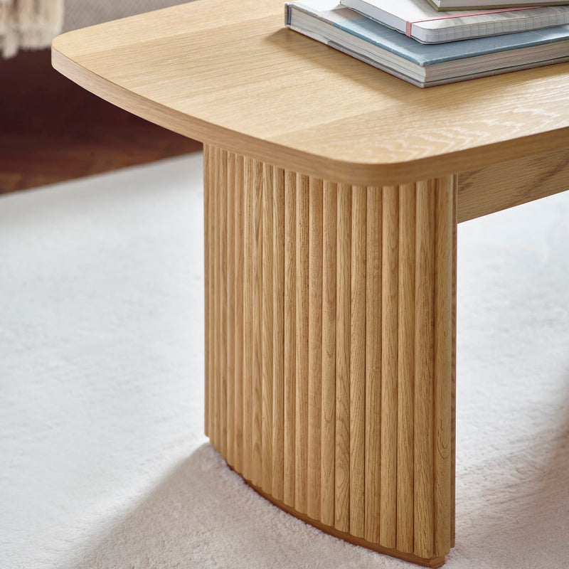 Wooden table leg on a white carpet