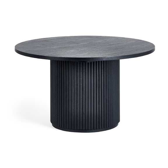 Round black dining table with ribbed cylindrical base on a white background