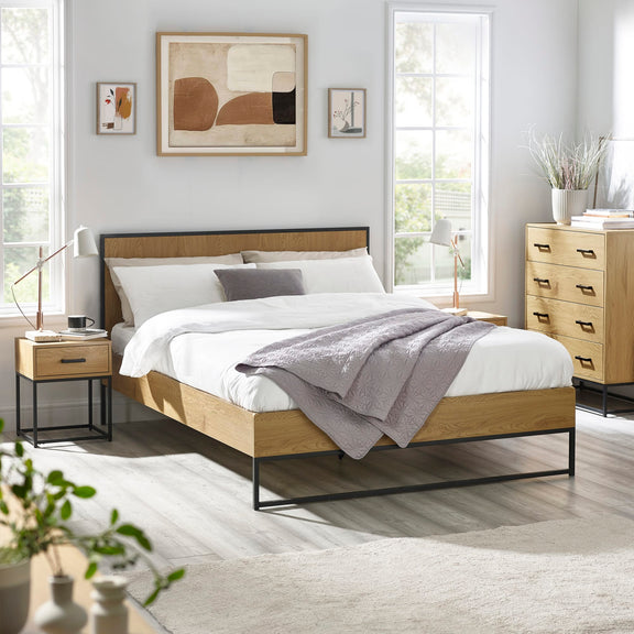 Modern bedroom with wooden bed, nightstands, and abstract art on the wall.