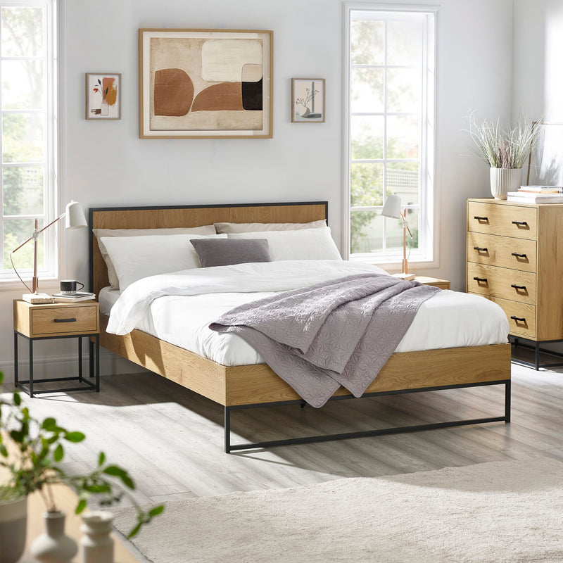 Modern bedroom with wooden bed, nightstands, and abstract art on the wall.