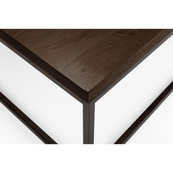 Close-up of a dark wooden table corner on a white background