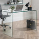 Glass desk with a laptop, plants, and office items in an office setting.