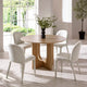 Dining room with a round wooden table and four white chairs.