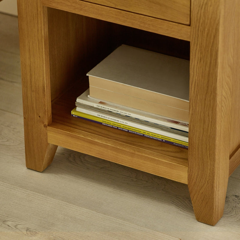Wooden side table with books on a wooden floor