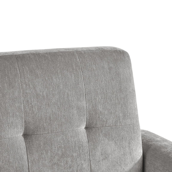 Gray upholstered chair with tufted design on a white background