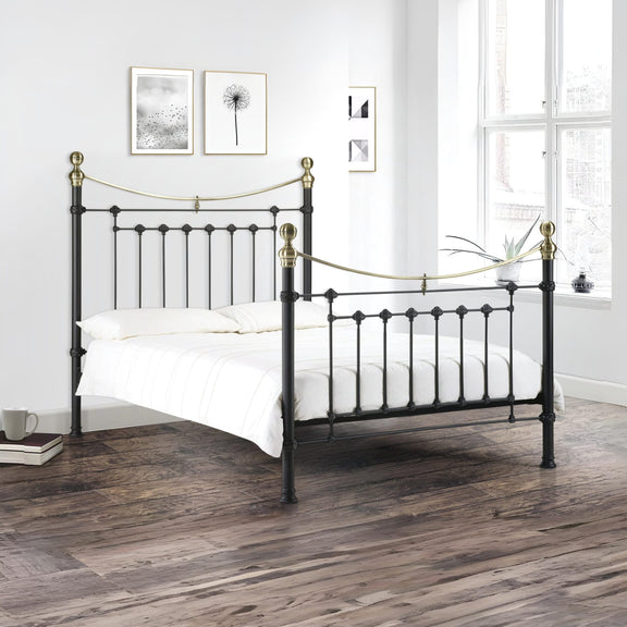 Black metal bed with gold accents in a bedroom setting