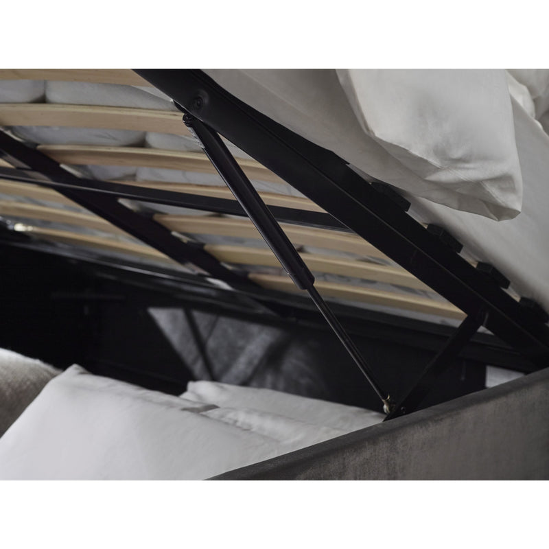 Close-up of a bed with a black metal frame and white bedding.
