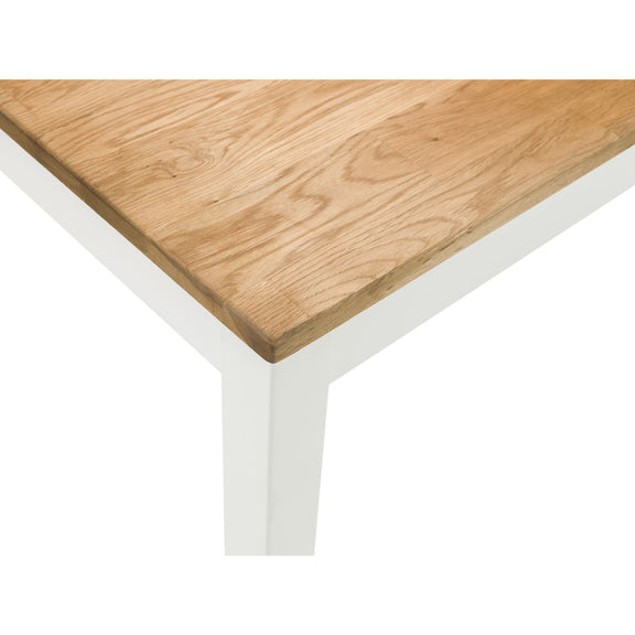 Wooden table top with white legs on a white background