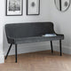 Gray quilted bench in a room with framed pictures on the wall.
