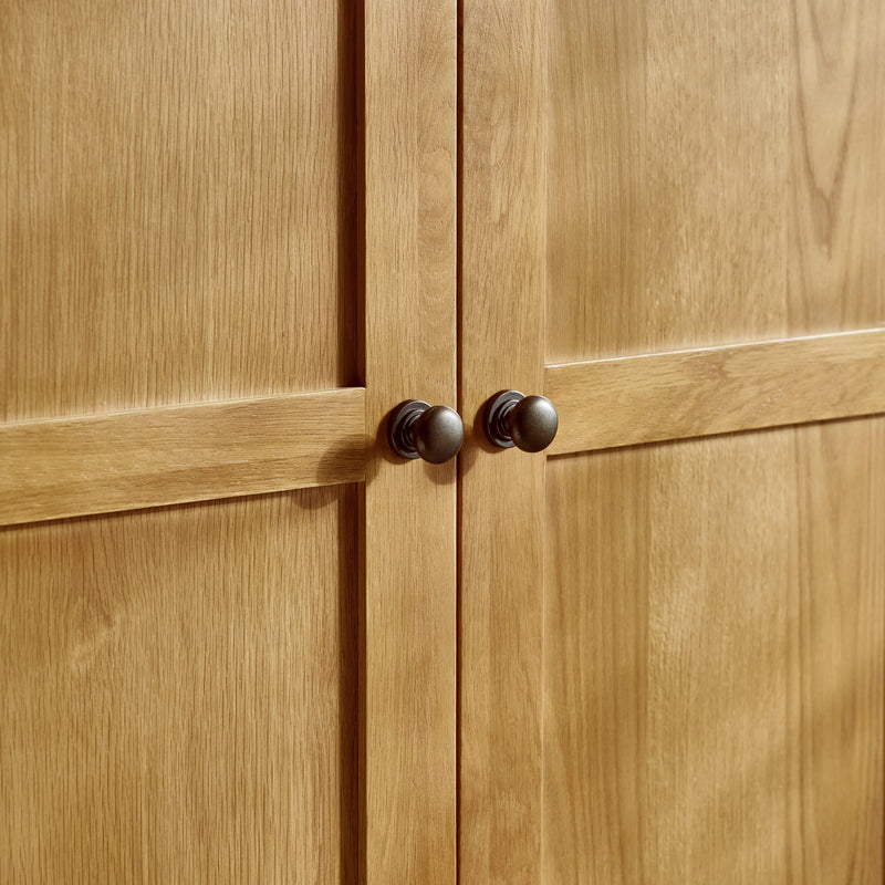 Close-up of wooden cabinet doors with dark handles