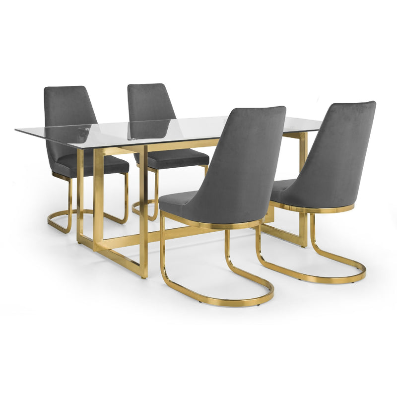Dining table with glass top and gold legs accompanied by four gray chairs on a white background