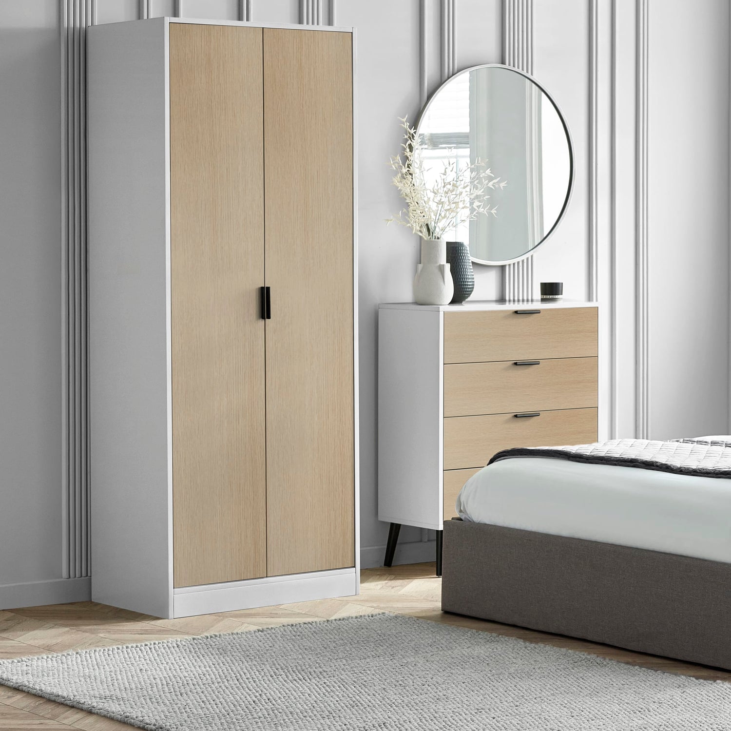 Modern bedroom with a wardrobe, chest of drawers, and bed.