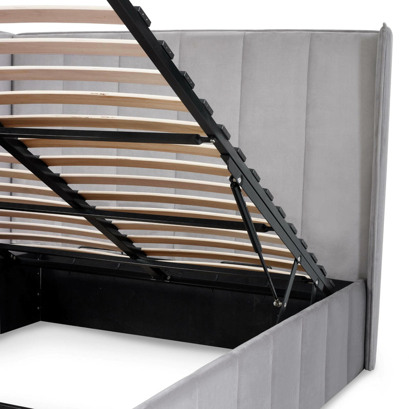 Wooden bed frame with mattress on a white background