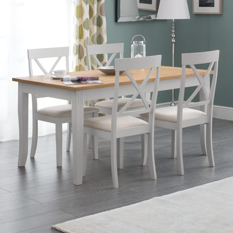 Dining room with a wooden table and white chairs on a gray floor.
