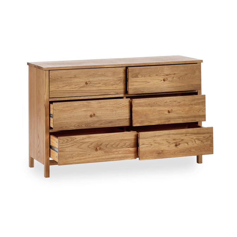 Wooden dresser with multiple drawers on a white background