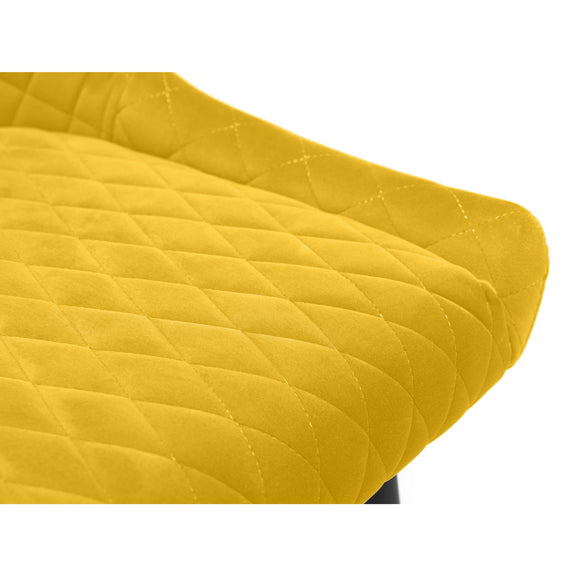 Close-up of a yellow quilted chair cushion on a white background
