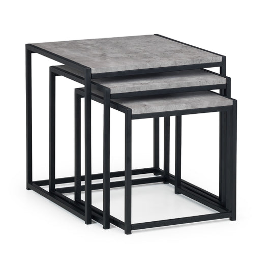 Set of three nesting tables with gray tops and black metal frames on a white background
