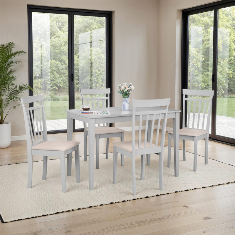 Gray dining table with four matching chairs in a room with large windows.