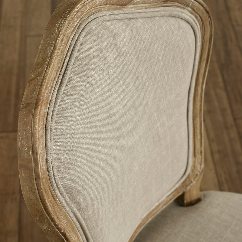 Close-up of a chair with wooden frame and beige fabric seat.
