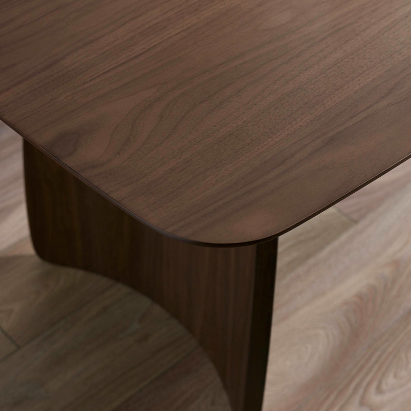 Close-up of a wooden table with a chair partially visible
