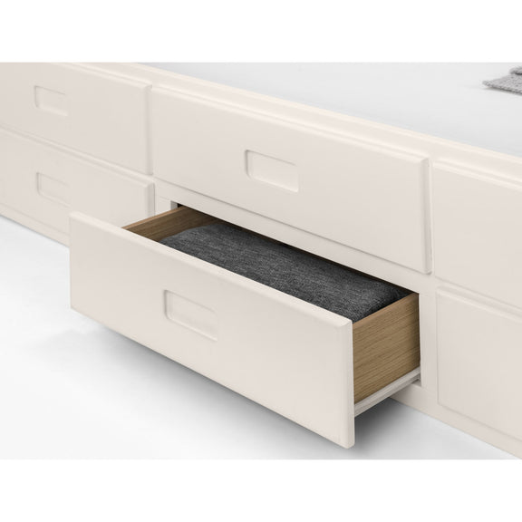 Open drawer of a white wooden furniture piece with a gray interior.