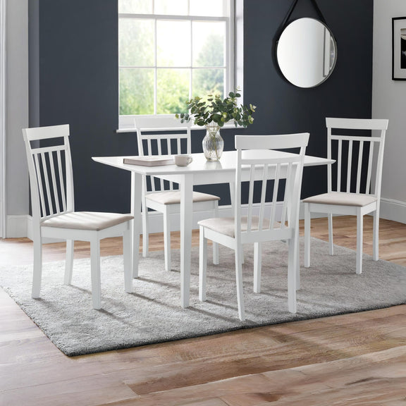 White dining set with table and chairs in a room with a window and mirror.