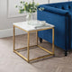 Gold side table with marble top next to a blue sofa