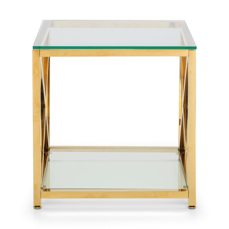 Gold side table with glass top and shelf on a white background