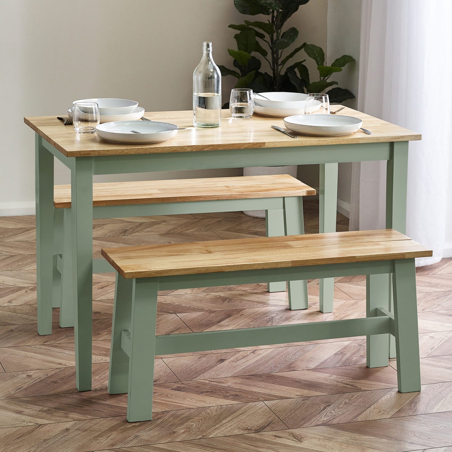Dining table with benches and tableware on a wooden floor