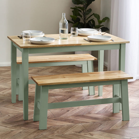 Dining table with benches and tableware on a wooden floor
