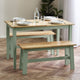Dining table with benches and tableware on a wooden floor