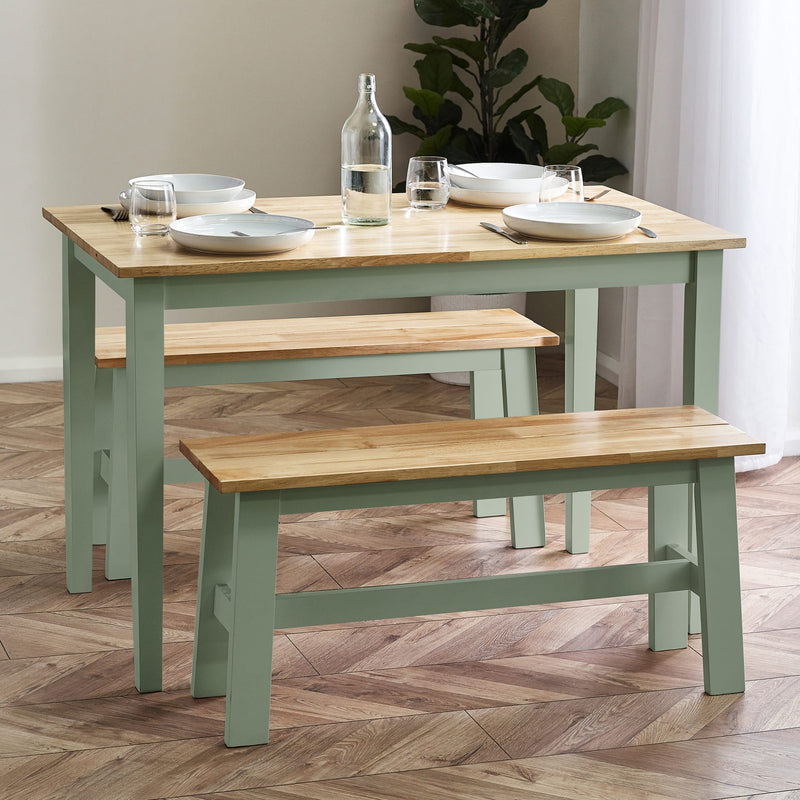 Dining table with benches and tableware on a wooden floor