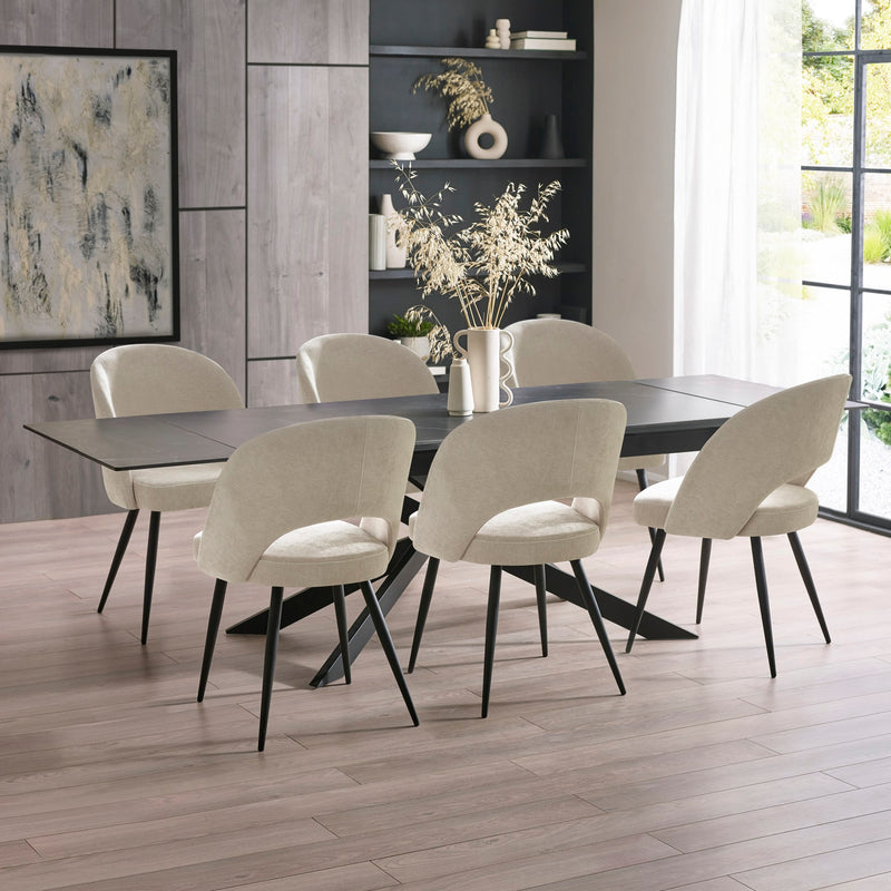 Dining room with a modern table and chairs in a well-lit room.