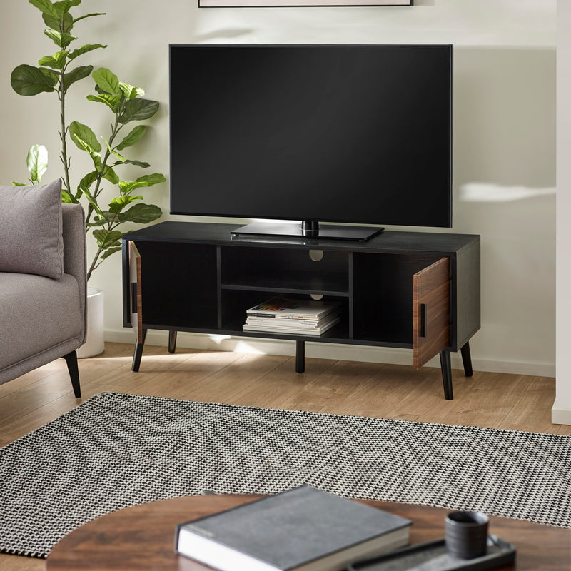 Modern living room with a black TV stand, gray sofa, and decorative items.