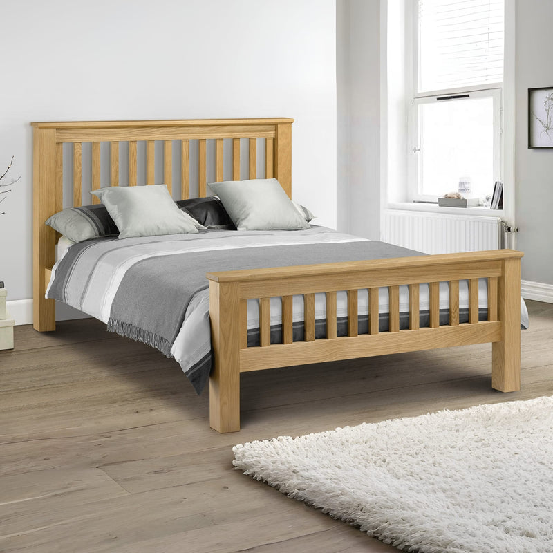 Wooden bed with gray bedding in a bedroom setting