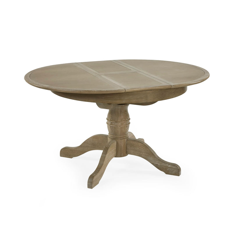 Round wooden dining table with a pedestal base on a white background