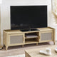 Wooden TV stand with a television on top in a room setting.