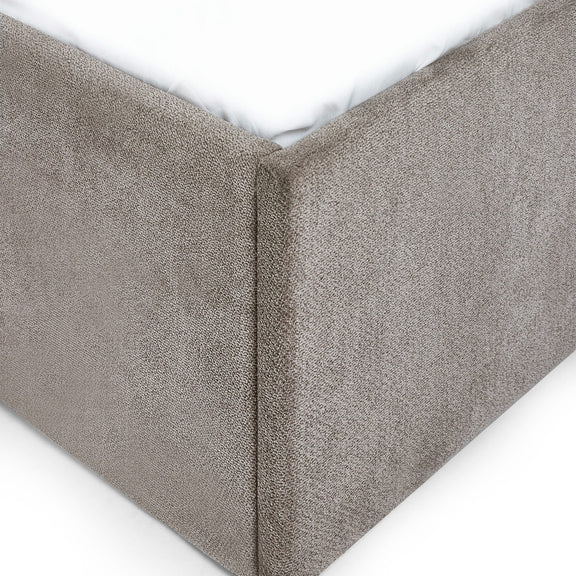 Textured gray fitted sheet corner on a white background