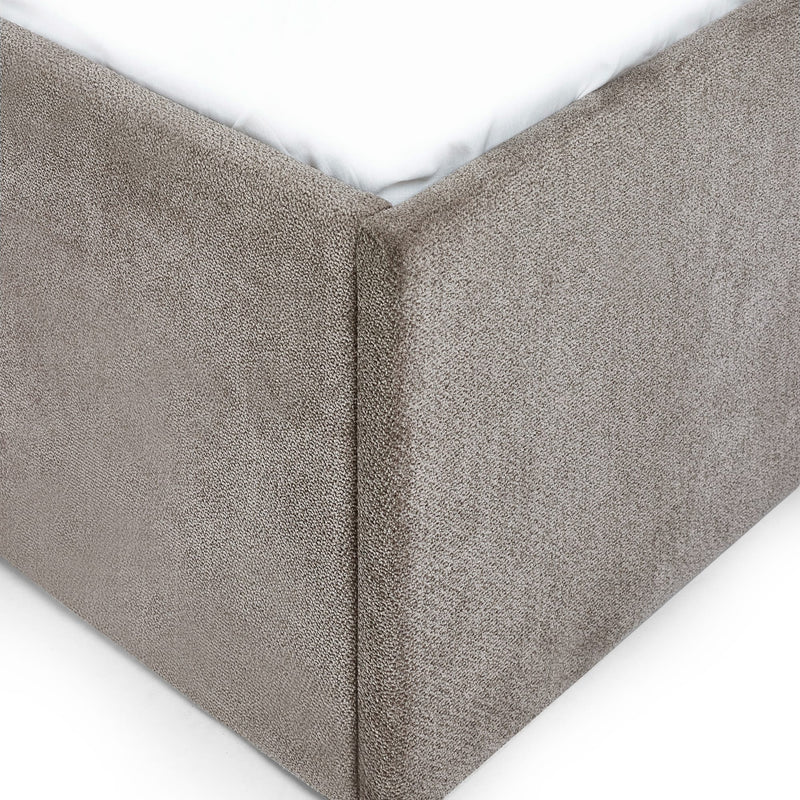 Textured gray fitted sheet corner on a white background