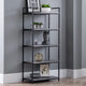 Black metal bookshelf with decorative items against a gray wall