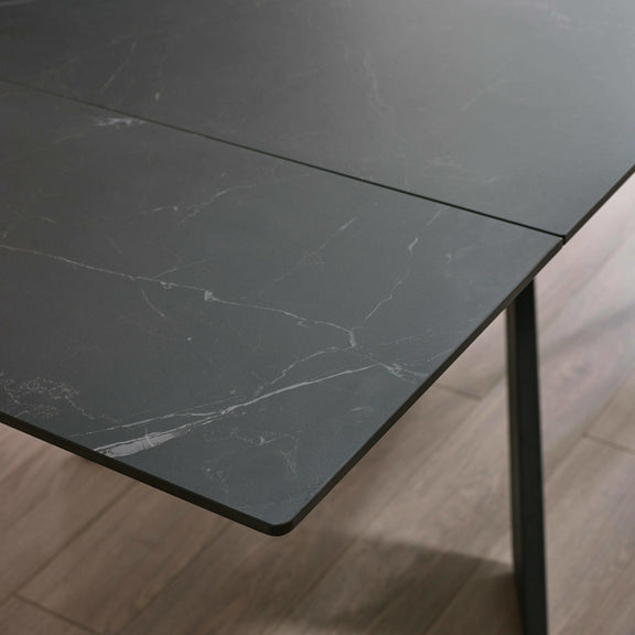 Dark marble-patterned table top on a wooden floor