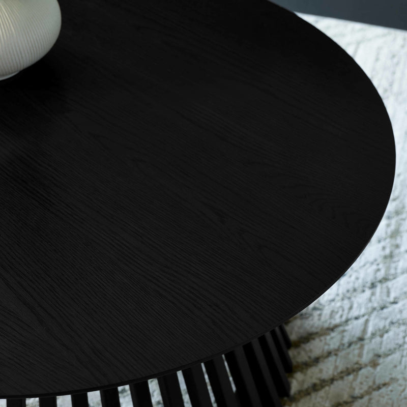 Close-up of a black comb with textured handle