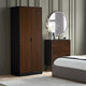 Wooden wardrobe and dresser in a bedroom setting with a round mirror and decorative elements.