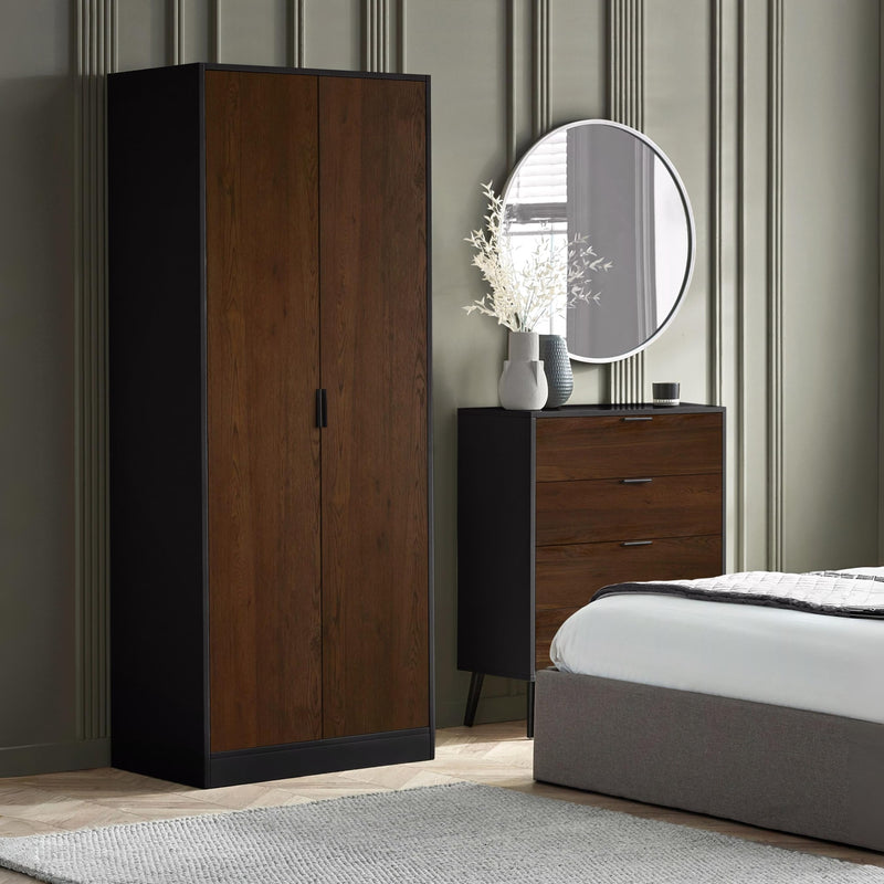 Wooden wardrobe and dresser in a bedroom setting with a round mirror and decorative elements.
