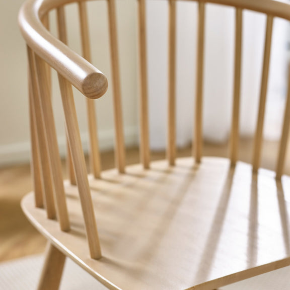 Close-up of a wooden chair with a blurred background