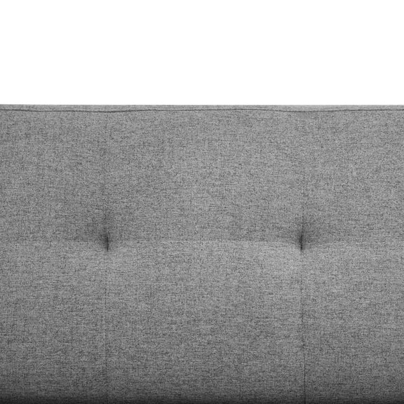 Gray upholstered headboard with tufted design on a white background