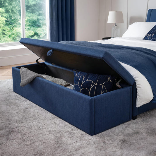 Navy blue storage bed with open lid in a bedroom setting.