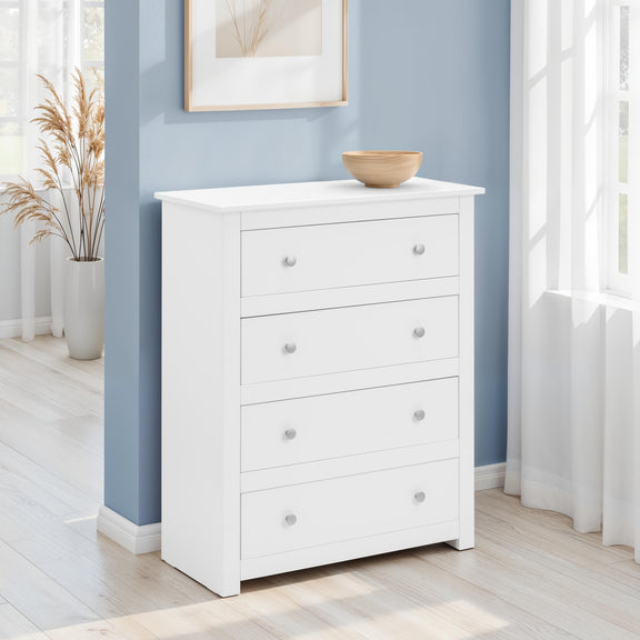 White dresser with four drawers against a blue wall in a room with natural light.