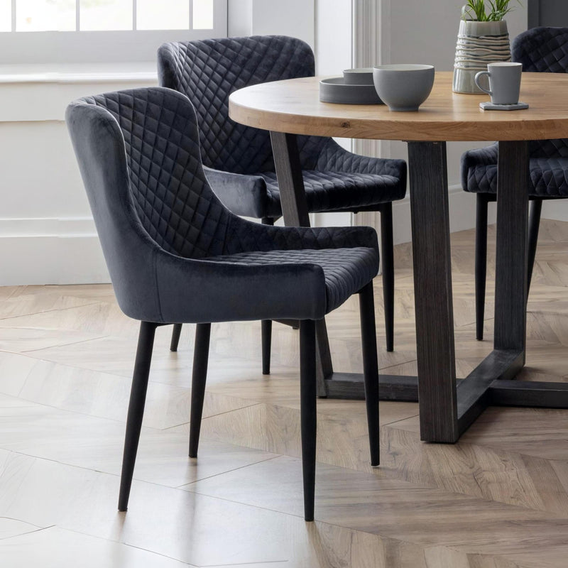 Dining room with dark gray chairs and a wooden table.